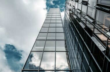 low angle photography of high rise building under cloudy sky