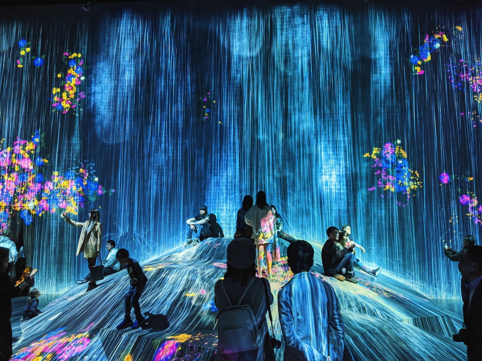 people dancing on stage with blue lights