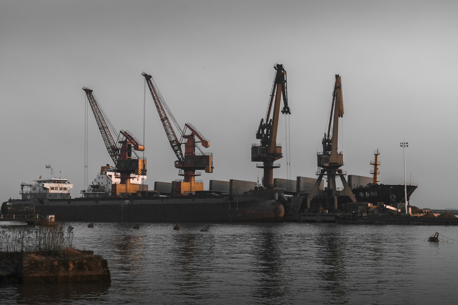 a large ship in the water with cranes on it