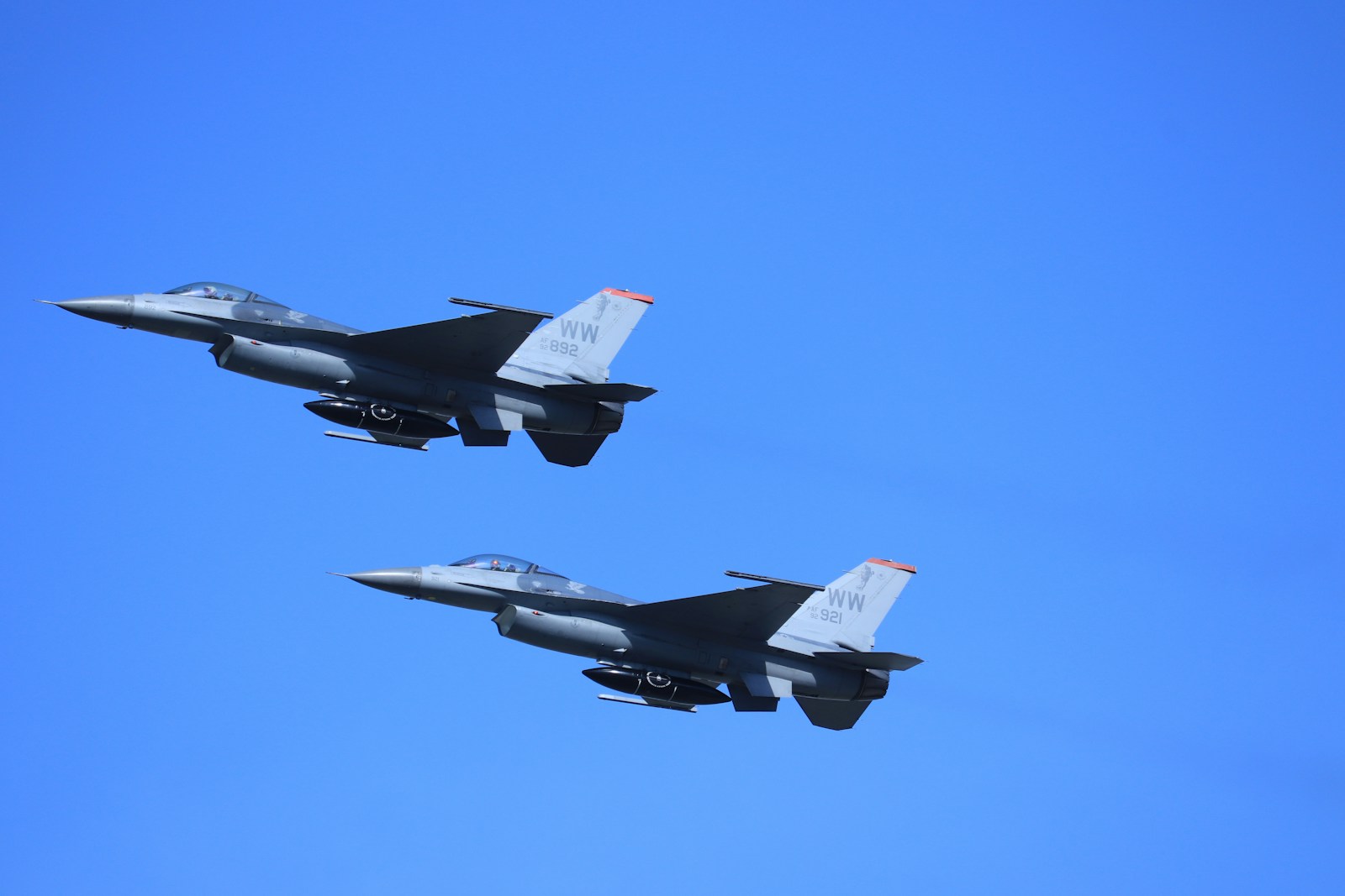 two fighter planes flying in the sky during daytime