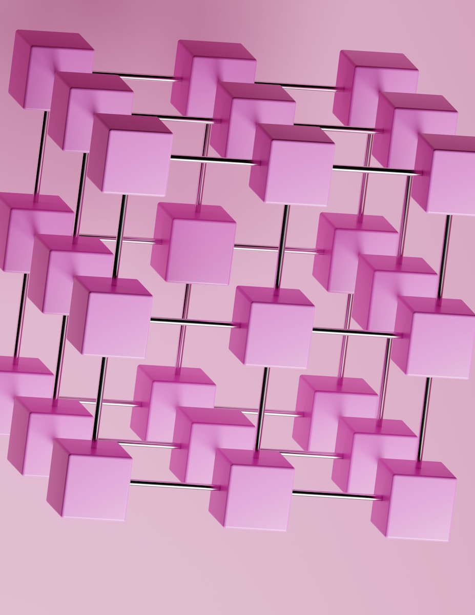 a bunch of pink cubes hanging from a pink wall